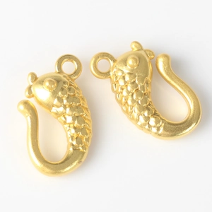 Detailed close-up of golden fish-shaped alloy connectors for DIY jewelry making