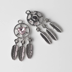 Close-up of dreamcatcher pendant with pink heart crystal and metallic feathers