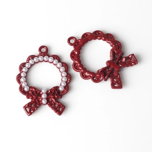 Detail of red floral wreath charms with bow knots and faux pearls for DIY jewelry