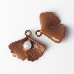 Detail of brown ginkgo leaf alloy pendants with pearl inlay for DIY jewelry crafting