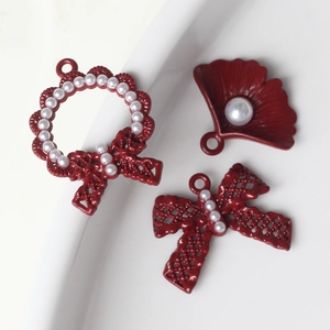 DIY jewelry set with dark red enamel flower, pearl bow, and shell pendants for crafts