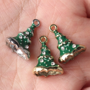 Green enamel Christmas tree pendants with rhinestones on hand for size reference