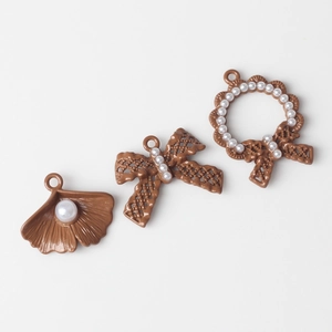 Brown alloy pendant charms with white pearls in shell, bow, and wreath designs