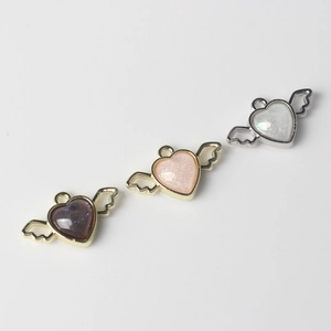 DIY heart wing resin charms in purple, pink, and white for necklaces and bracelets