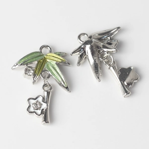 Macro view of bamboo leaf and flower pendant with enamel glaze and zircon inlay detail
