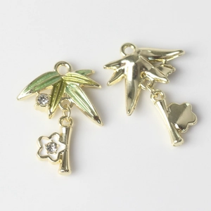 Detail of gold alloy bamboo leaf and flower pendants with green enamel and zircons
