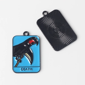 Detail of tarot death card pendant showing front enamel art and back textured metal finish