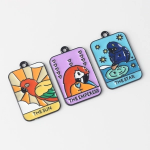 Macro view of colorful enamel tarot pendants featuring cartoon parrots on white background
