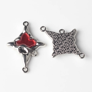 Detail of silver alloy cross connectors with red enamel hearts for DIY jewelry