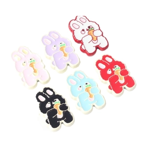 Flat lay of cartoon rabbit alloy pendants in six colors for DIY jewelry making