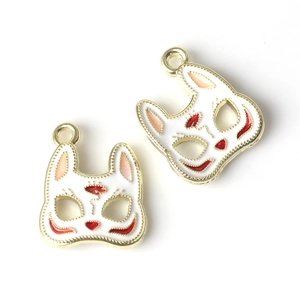 Detailed close-up of Japanese style fox mask pendants with white enamel and red patterns
