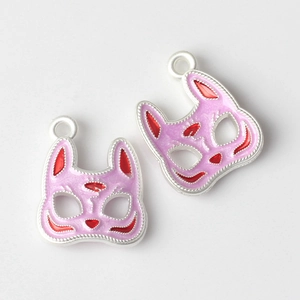 Detailed view of pink and purple fox mask alloy charms with Japanese drip oil finish