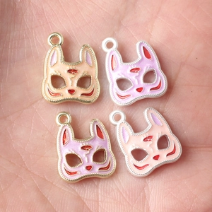 Japanese style fox mask alloy charms with colorful oil drip finish held in palm