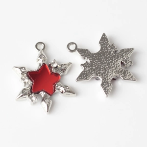 Macro detail of alloy hexagram pendants with red resin star inlay for DIY jewelry crafts