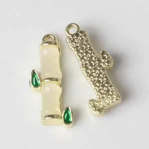 Macro shot of bamboo leaf pendant showing smooth jade resin texture and golden metal back