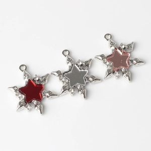 Close-up of star snowflake charms with resin inlays and rhinestones for DIY jewelry