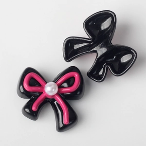 Detail of alloy bow charm with pearl accent for DIY jewelry making and hair accessories