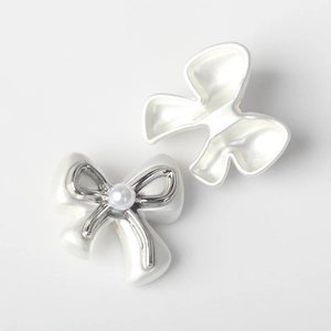 Detailed front and back views of white resin bow charms with imitation pearl and silver trim