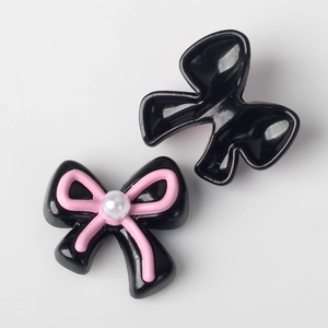 Detail of alloy bow charms with resin pearl inlay for DIY jewelry bracelet making