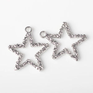 Close-up of silver alloy star charms with hammered texture for DIY jewelry making