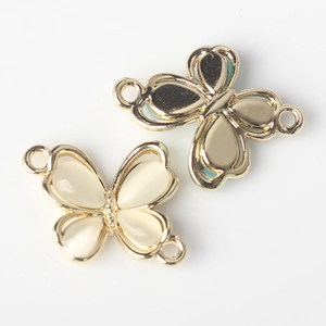 Detail of butterfly connector in gold alloy with white and blue opal resin for DIY jewelry