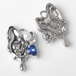 Detailed view showing the front and textured back of a heart-shaped blue crystal pendant