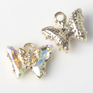 Detailed view of golden butterfly charms with iridescent crystals for DIY jewelry making