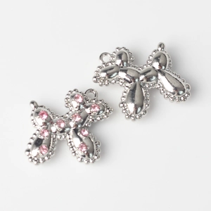 Detail of silver balloon dog charms with pink rhinestone and polished alloy finish