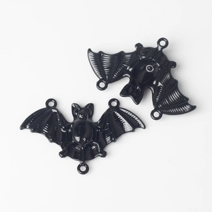 Close-up of black alloy bat connector charms with 3 loops for DIY jewelry making