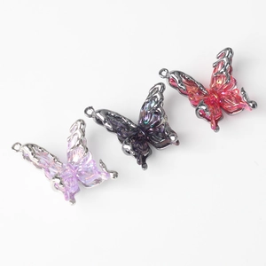 Detailed view of three resin butterfly charms in purple and pink for DIY jewelry making
