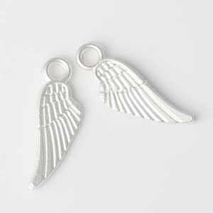 Detailed pair of silver alloy wing charms with intricate feather textures for jewelry making