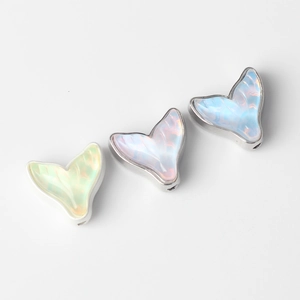 Three colorful resin mermaid tail beads for DIY jewelry making in pink, blue, and yellow