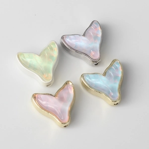Set of four resin fishtail charms with metal borders for DIY jewelry making