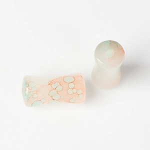 Macro view of pastel watercolor glass bamboo-shaped beads for DIY jewelry making