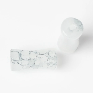 Detail of white marble textured bamboo style glass beads for DIY jewelry and accessories