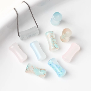 Detail of colorful bamboo-shaped glass beads and marble texture DIY jewelry components