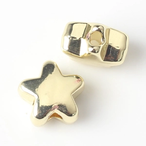 Detalle macro de cuenta de estrella dorada y espaciador metálico para joyería