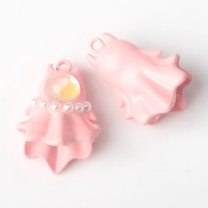 Detail of pink ghost charms with pearl accents and matte finish for jewelry making