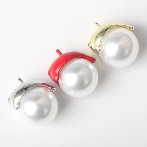 Detailed view of pearl acorn pendants in silver, red, and gold for DIY jewelry making