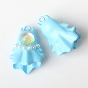 Detail of light blue ghost charm with white faux pearls and gold glitter inlay for DIY jewelry