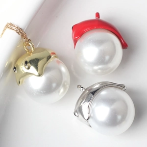 Detailed view of alloy pearl ghost charms in gold, red, and silver finishes for jewelry