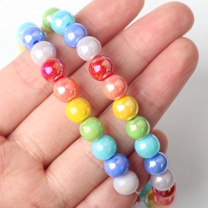 Detailed macro of 8mm colorful glass beads with rainbow pearl luster for DIY jewelry