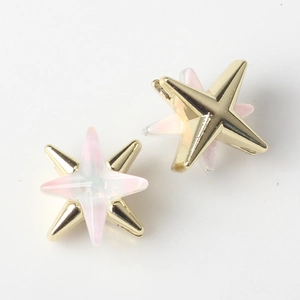 Close-up of double-layered star pendants with gold alloy and pink resin inlay details