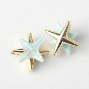 Close-up of double-layered star pendant with gold alloy and light blue resin inlay