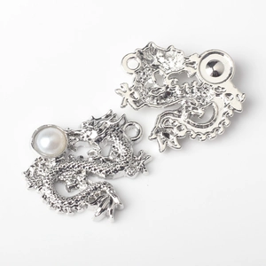Detail of silver alloy dragon pendant charms with white pearl inlay for DIY jewelry