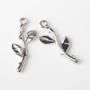 Detailed view of silver branch charms with leaf design and mirror polished finish