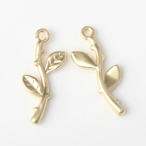 Macro detail of golden metal branch pendants with realistic leaf texture for DIY jewelry