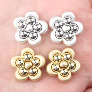 DIY flower alloy beads for jewelry making in silver and gold finishes held in palm