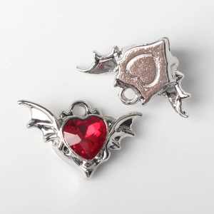 Detailed front and back view of silver bat wing pendant with red heart stone