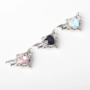 Detail of bat-winged heart pendants with pink, black, and iridescent zircons for DIY jewelry